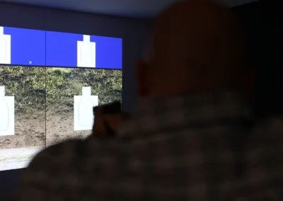 Over-the-shoulder view of a participant using a projected target simulator.